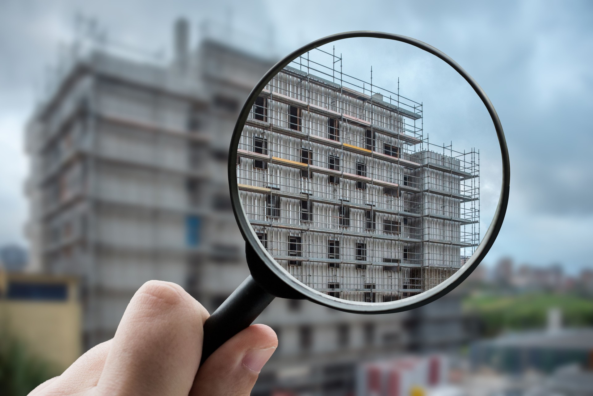 Magnifying glass focusing a building under construction