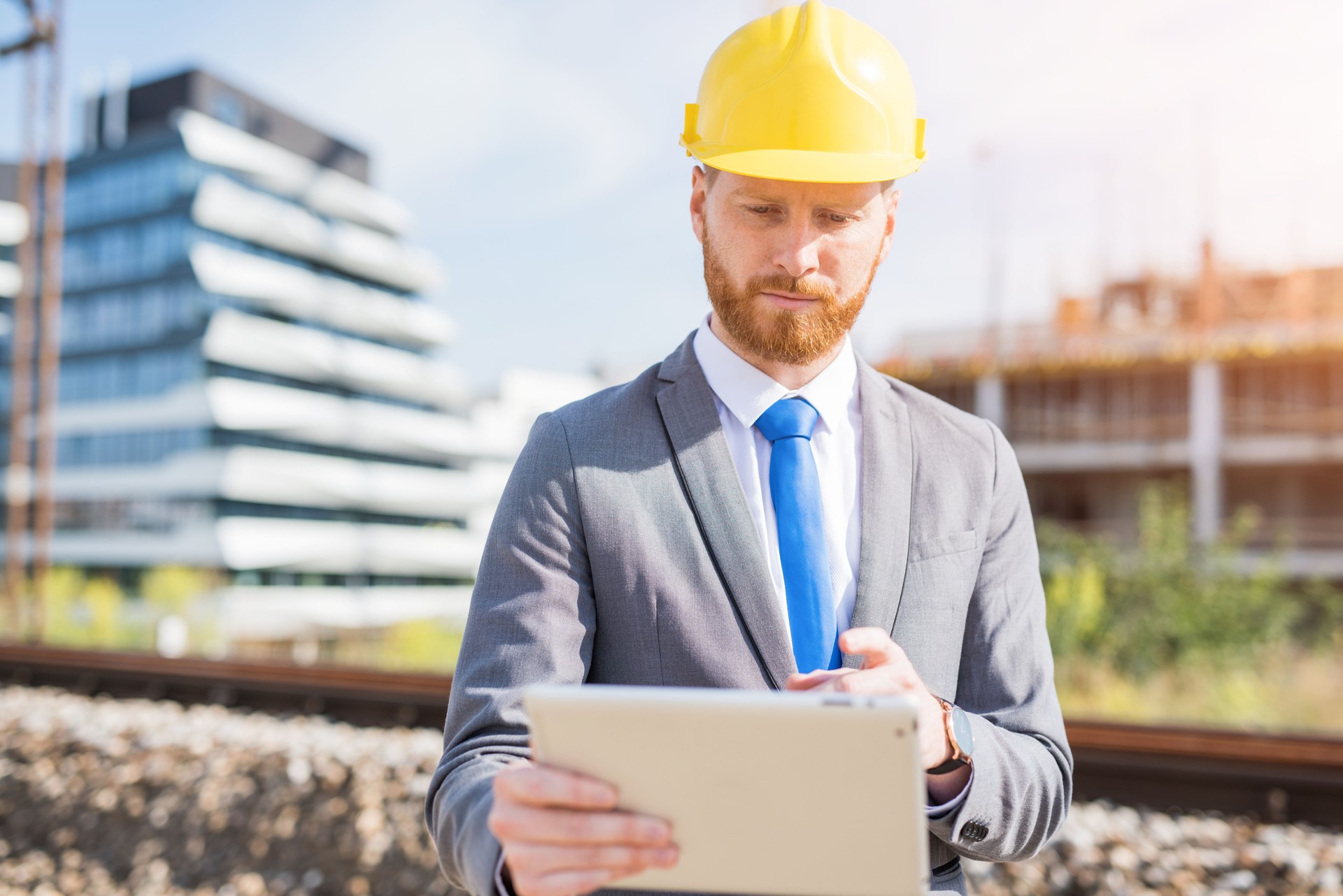 Young engineer using a digital tablet on a construction site.